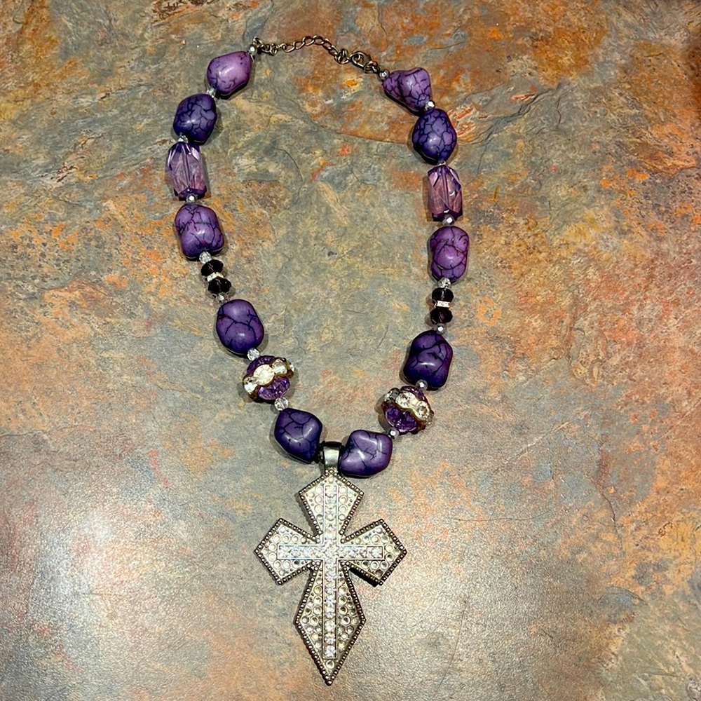 Women’s purple western cross necklace with matching earrings.